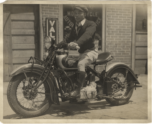 Vintage african man on motorcycle. 