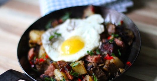 A frying pan with a fried egg and potatoes, perfect for St. Patrick's Day.