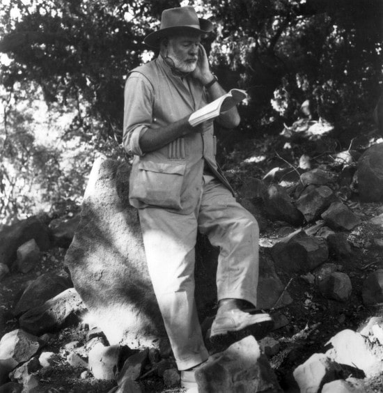 ernest hemingway outdoors on hike reading book 