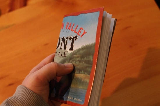 A man holding a notebook in his hand.