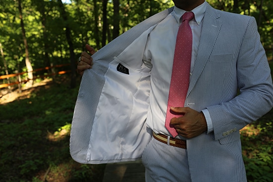 A man showing lining of seersucker suit.