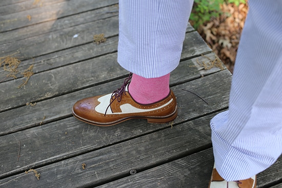 A man wearing shoes and socks made by seersucker. 