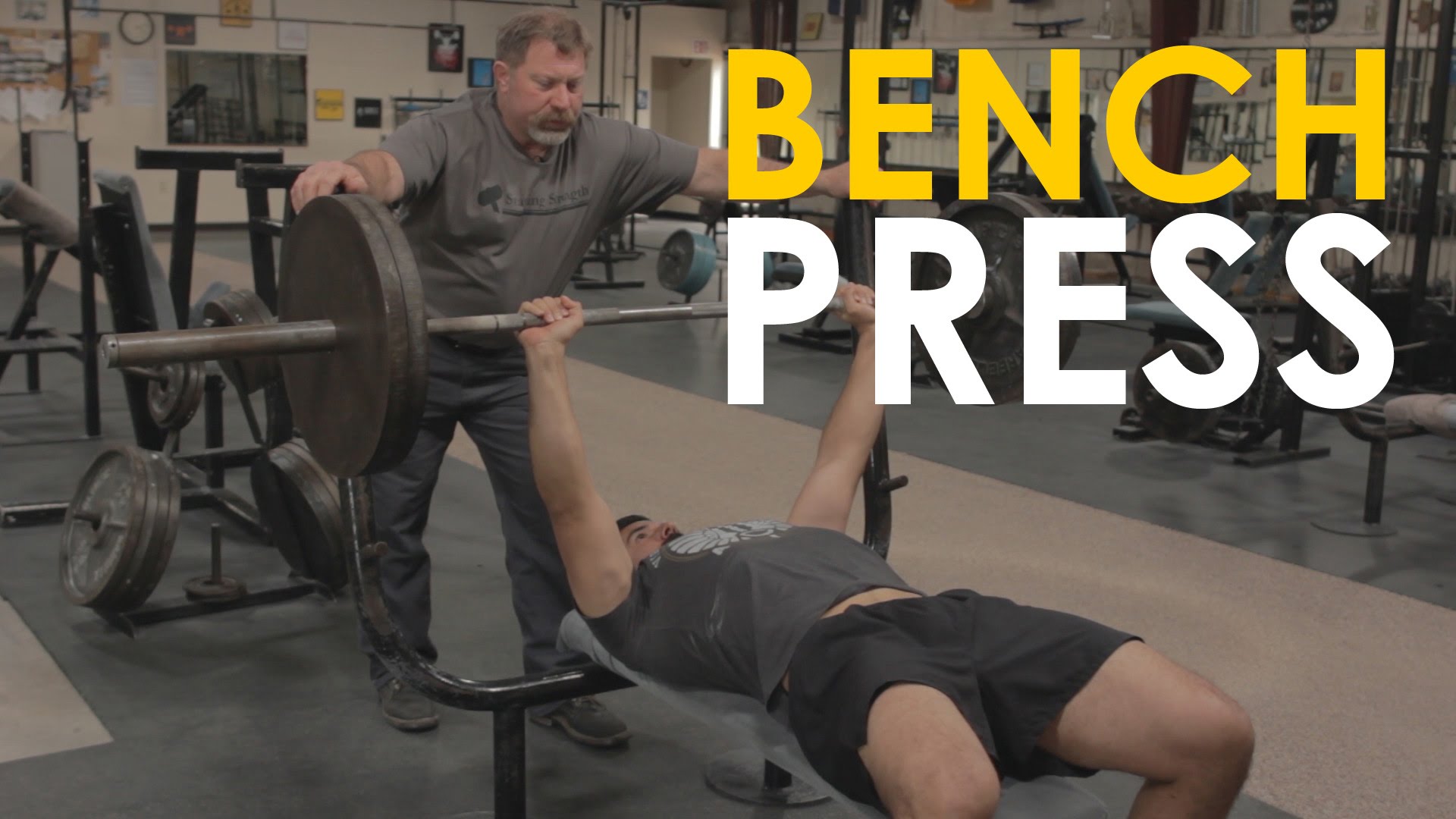 A man, bench pressing at the gym.