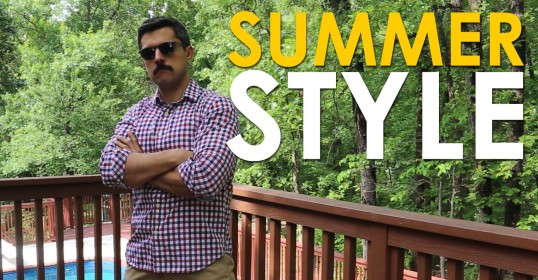 A man standing on a deck showcasing his casual summer style.