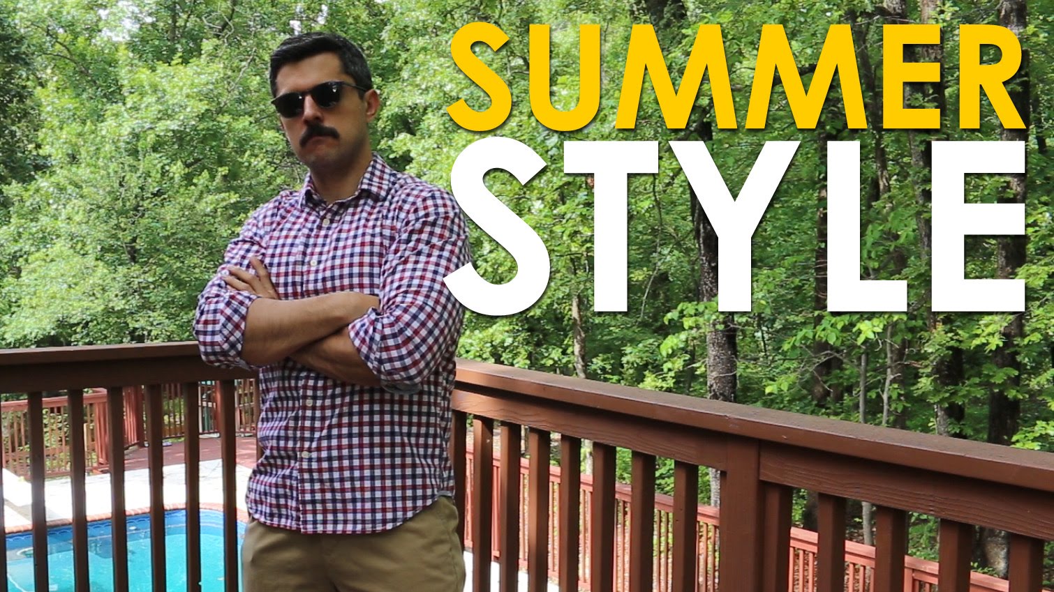 A man standing on a deck showcasing his casual summer style.