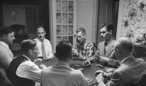 A group of men playing poker at a table.
