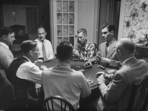 A group of men playing poker at a table.