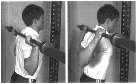 Man lifting barbell behind head without weights. 