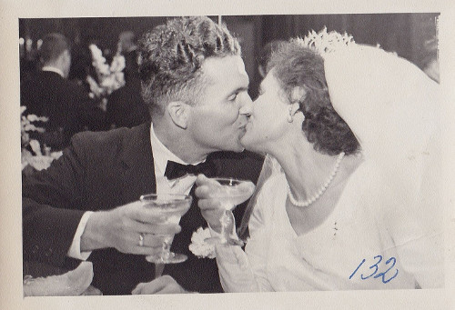 Vintage couple kissing on wedding day.