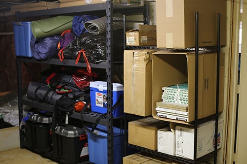 Garage shelves camping and sporting equipment.