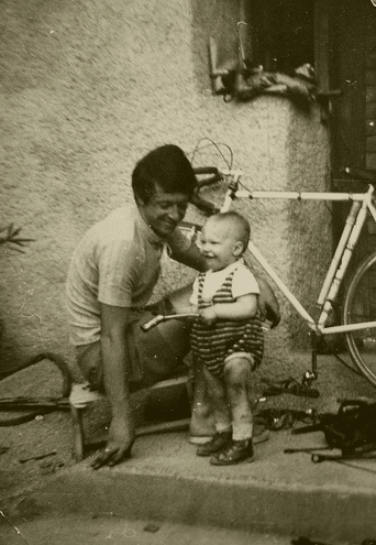 Vintage cyclist father with bike and baby.