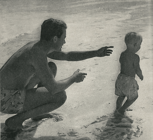 Vintage father child on beach.