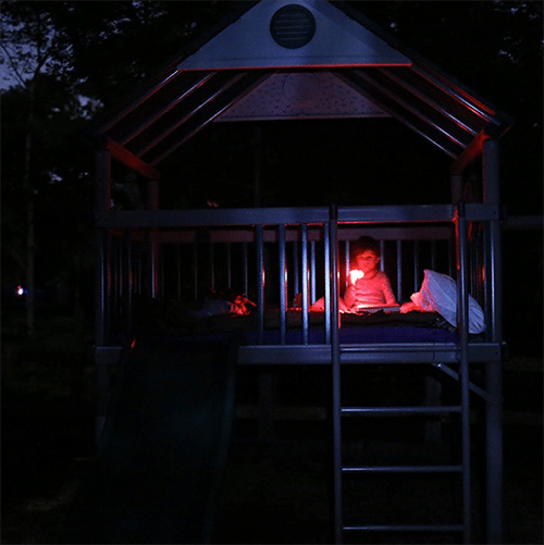 Boy camping in backyard Tree house.