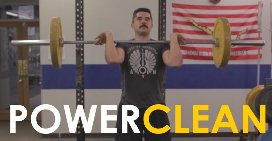 Learn how to power clean by watching this video of a man lifting a barbell in a gym.