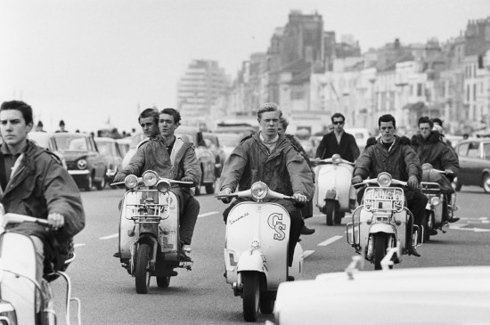 Vintage 1950s 1960s young men on scooters.