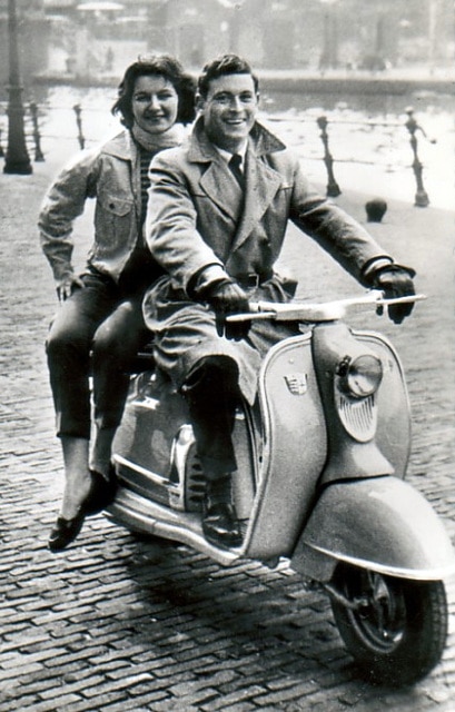 Vintage couple 1950s 1960s scooter.