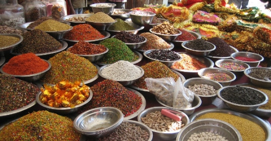 At the market, several bowls of spices are showcased for you to blend your own unique flavors.