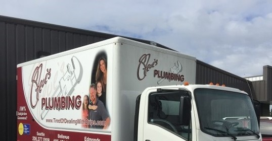 A white truck parked in front of a building.