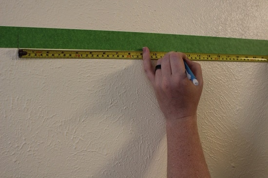 Hang a picture on the wall measuring.