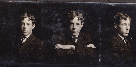 A photo of a young man in a stylish suit.