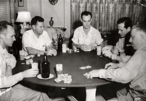 A group of men gathered around a table for Poker Night.