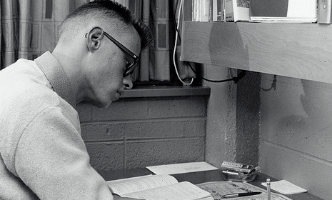 A young man sitting at an important desk.