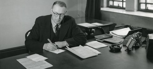 Vintage 1940s 1950s man writing desk office.