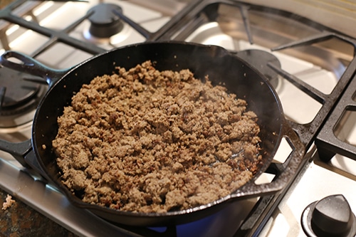Cooked browned sausage in cast iron skillet.
