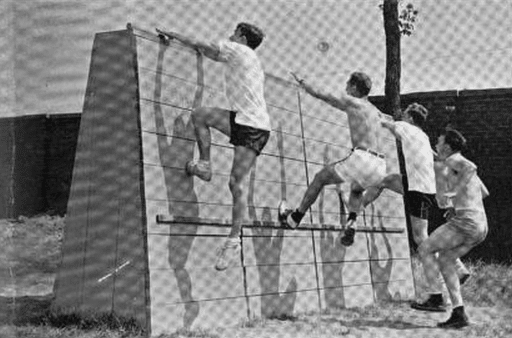 University of Michigan students tackle the obstacle course built on Ferry Field during the war.