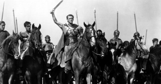 A group of men on horses with swords, resembling Gladiators.