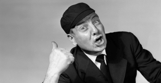 A black and white photo of a man giving a thumbs up, symbolizing positivity in life.