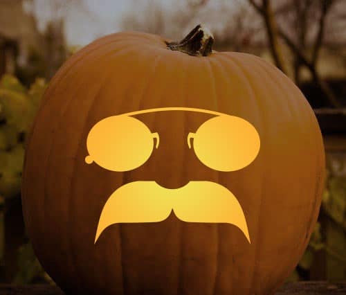 Pumpkin carving of mustaches and gougles.