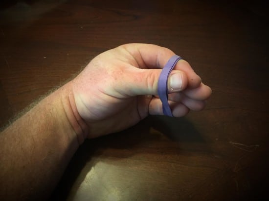 Fingers tied with a rubber band.