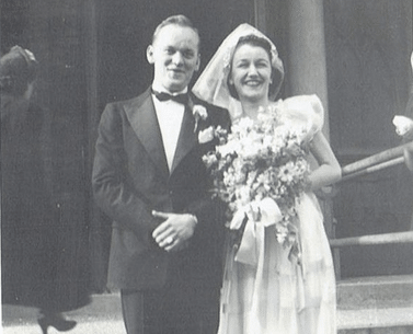 A black and white photo of a groom and bride.