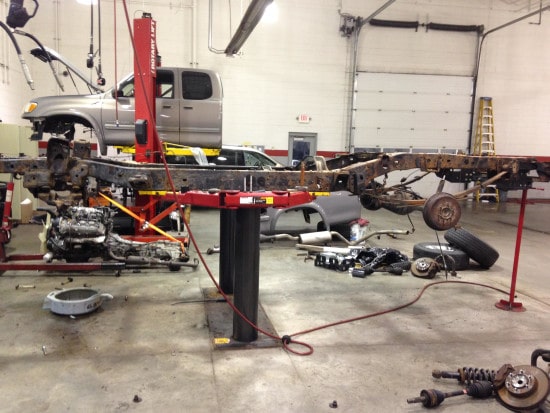 Disassembled truck in auto body shop getting assembled and repaired.