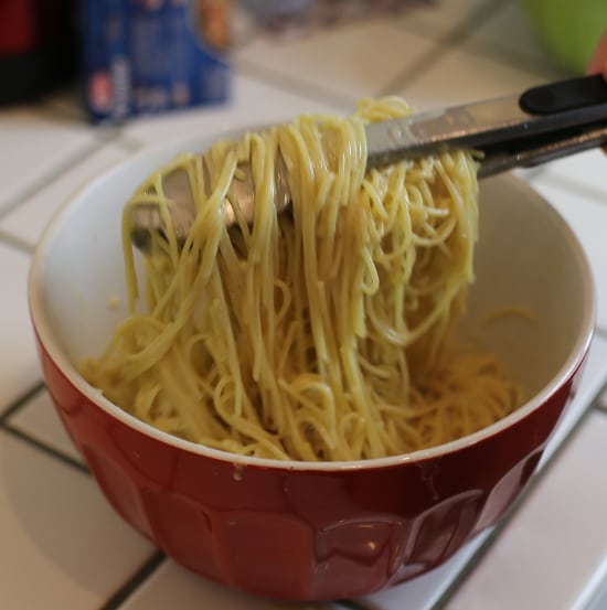 Tossing Cooked Pasta in Bowl with Egg mix Carbonara. 