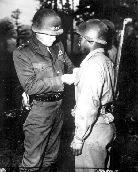 Officer giving badge to Sargent.