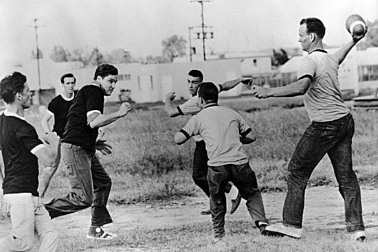Vintage young men playing pick up backyard football.