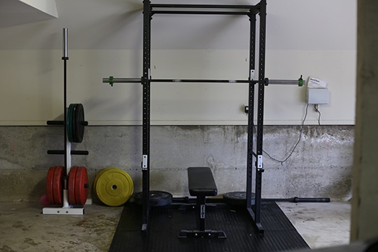 Home Garage GYM squat rack, bench and weight plates.