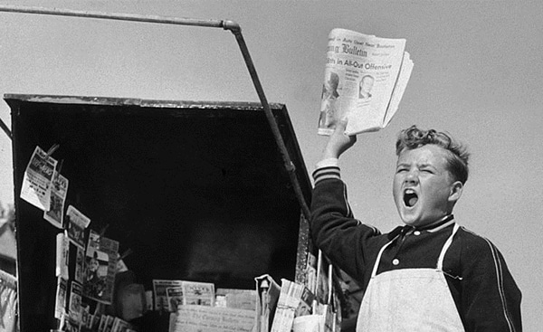 Vintage boy selling a newspapers. 