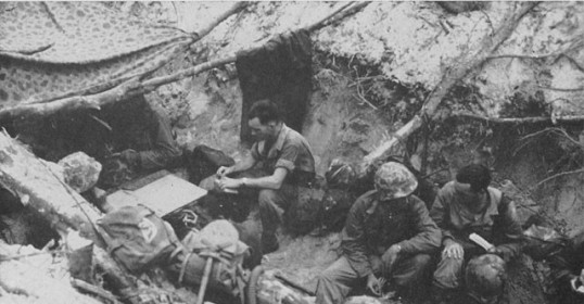 A group of soldiers, led by Lieutenant Edward Jones, are sitting in a cave.