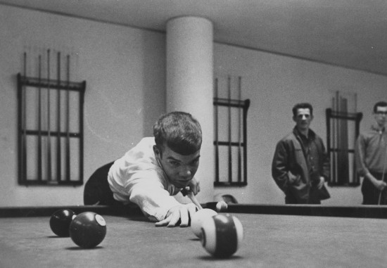 Vintage man playing pool billiards photo from table.