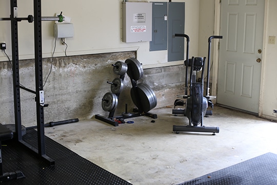 Home Garage GYM Airdyne bike and iron lifting plates.