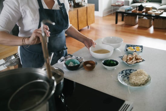 Chef Sarah is dishing chicken broth into large bowl. 