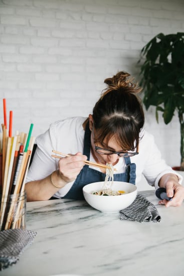 Chef Sarah is eating noodles. 