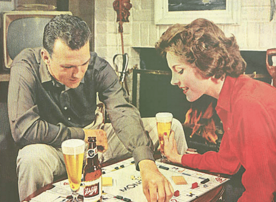 vintageman woman couple drinking beer playing monopoly 