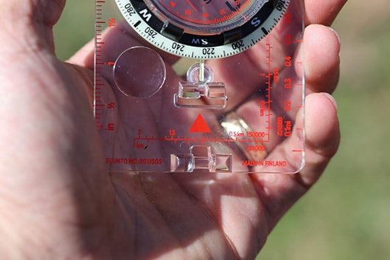A man holding a compass.