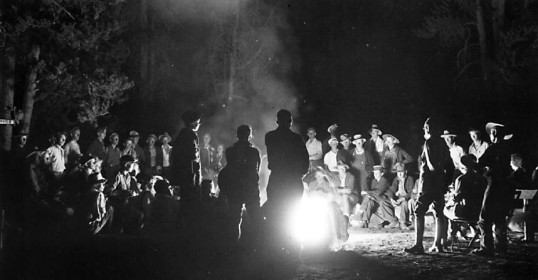 A group of people sat around a campfire, sharing stories and laughter.