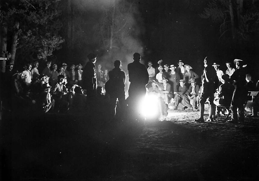 A group of people sat around a campfire, sharing stories and laughter.