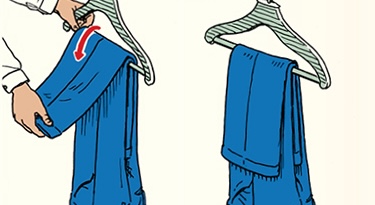 Illustration demonstrating the skill of the week: how to hang dress pants properly. The image shows an arrow indicating the folding direction, ensuring your pants won't fall off the hanger.